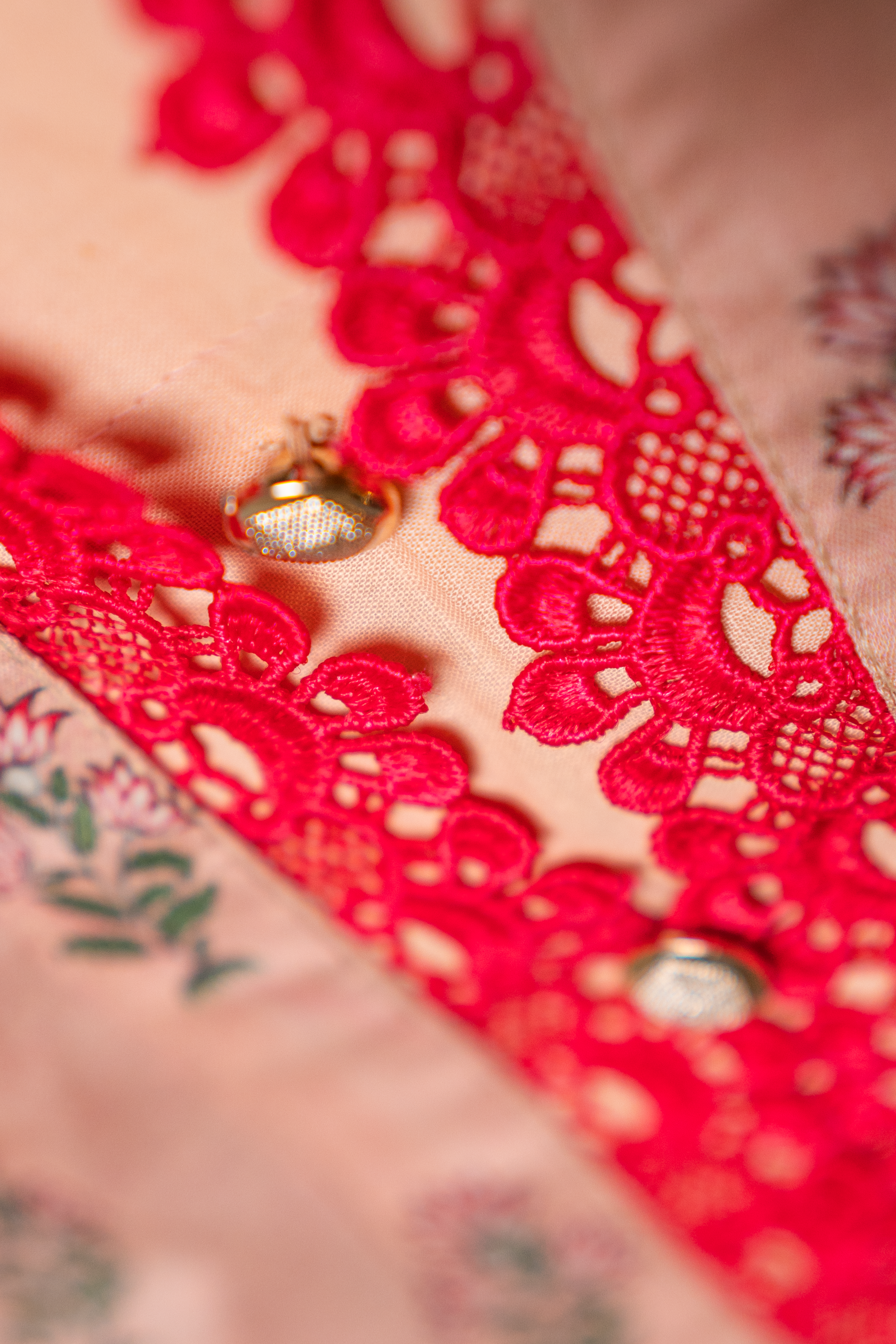 Embellished lacework neckline detail of peach festive pret outfit