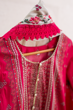 Embellished lace neckline detail of bold pink festive outfit