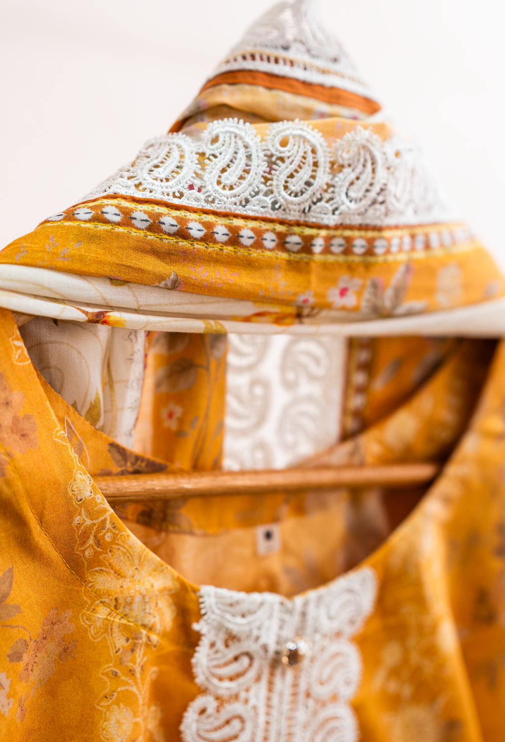 Embellished lacework neckline detail of mustard festive pret outfit