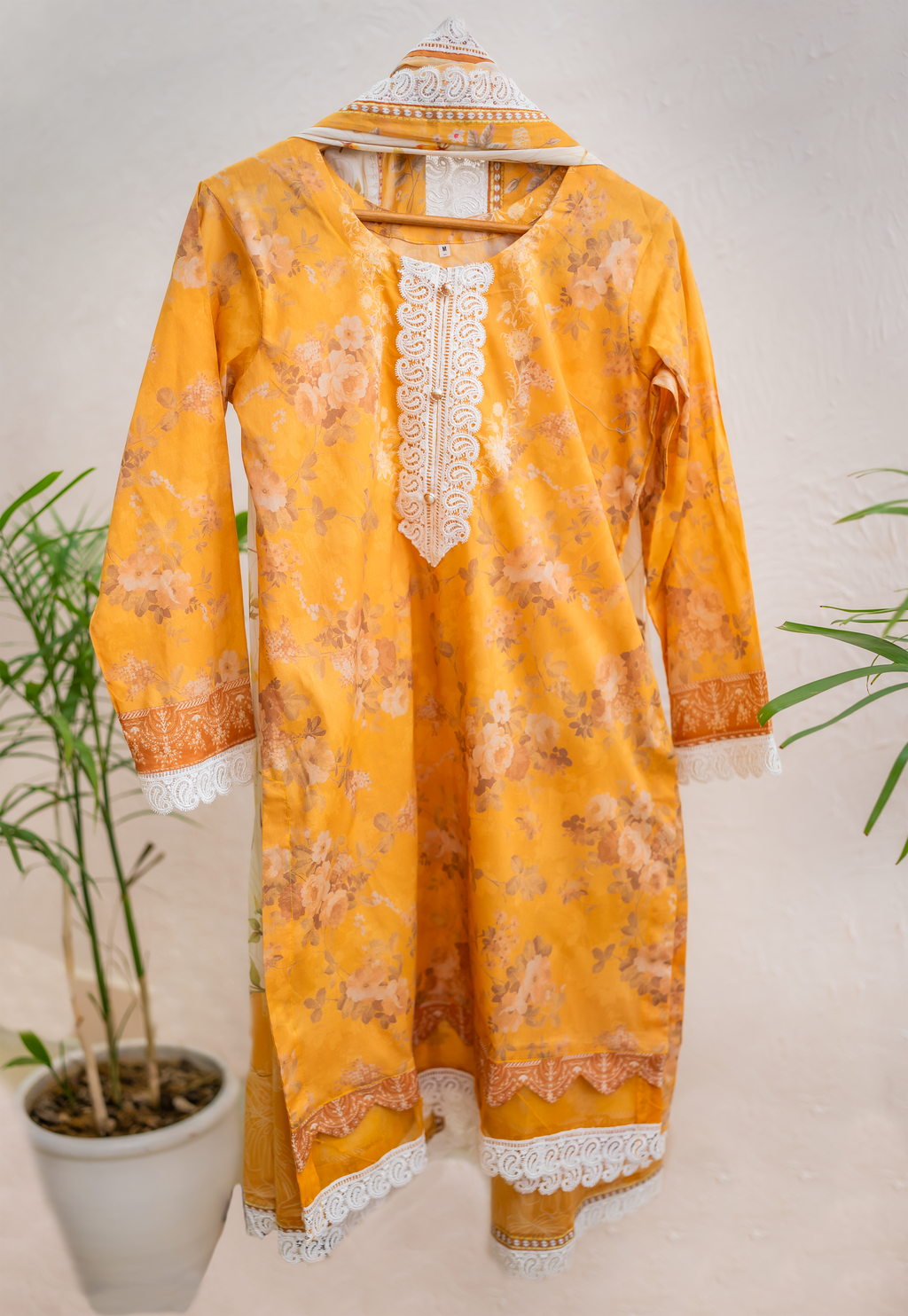 Saffron Lumière mustard luxury Eid pret by Eviline Couture with floral print and lace detailing